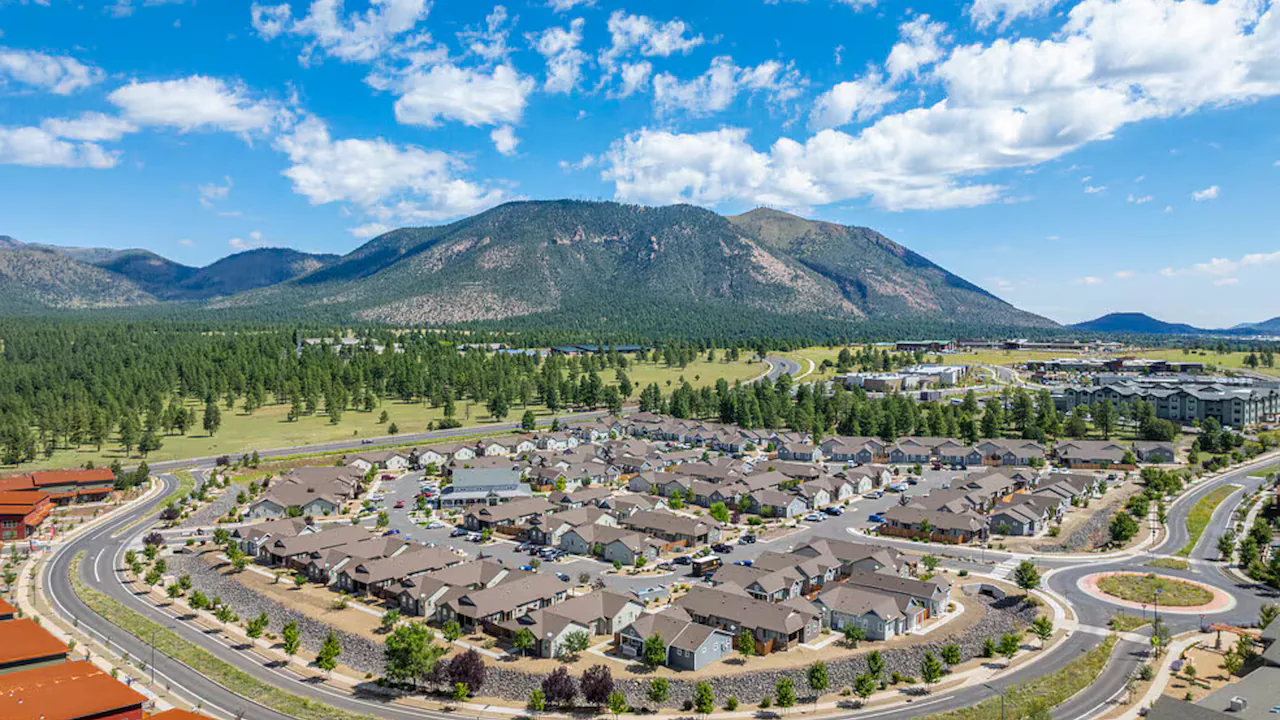 Aerial photo of a pine-ringed neighbourhood below the peaks south of Flagstaff, Arizona