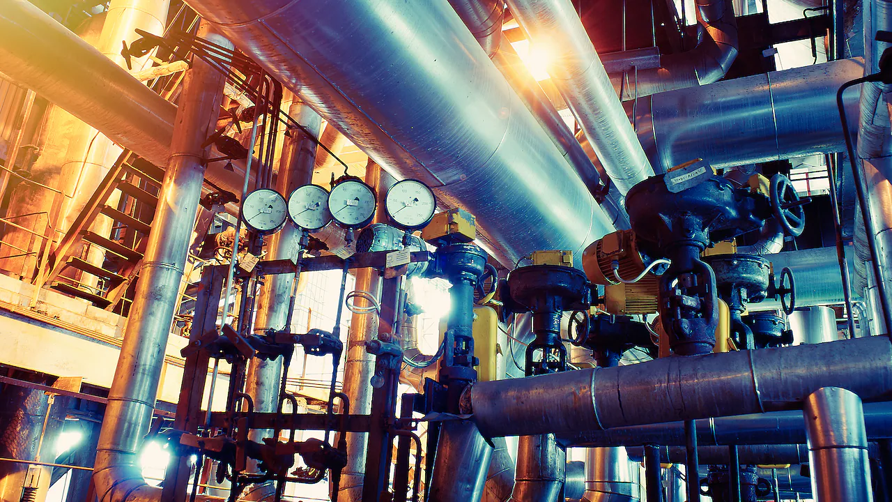 Industrial pipework, gauges and valves in a commercial mechanical room